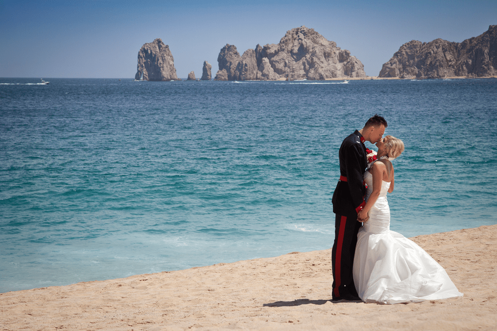 Los Cabos Mexico Liz Moore Weddings couples embrace on beachfront