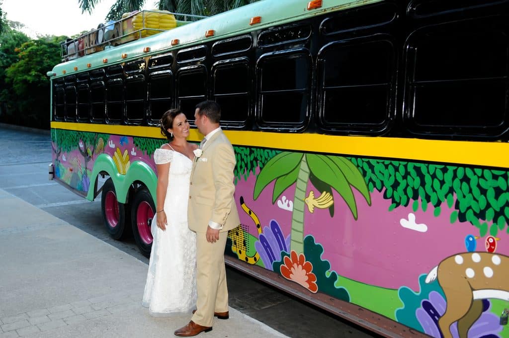 wedding couple beside bus at Playacar Palace. 