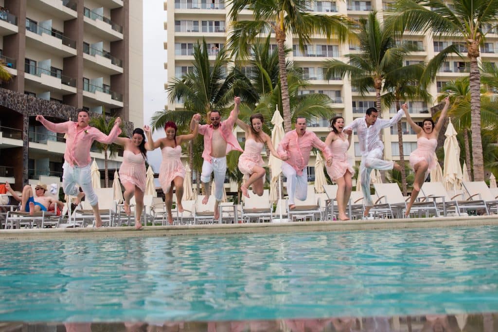 Picture of wedding party jumping in pool