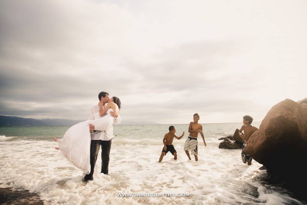 2 bride and groom kiss in the water 