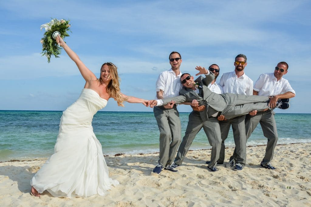 Bride and groomsmen on Grand Sunset Wedding beach 