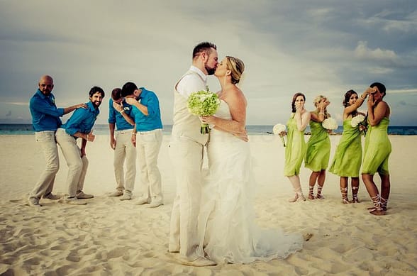 Bride and groom with bridal party on the beach. 