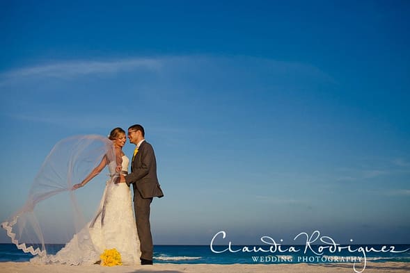 Couple with wedding veil on beach
