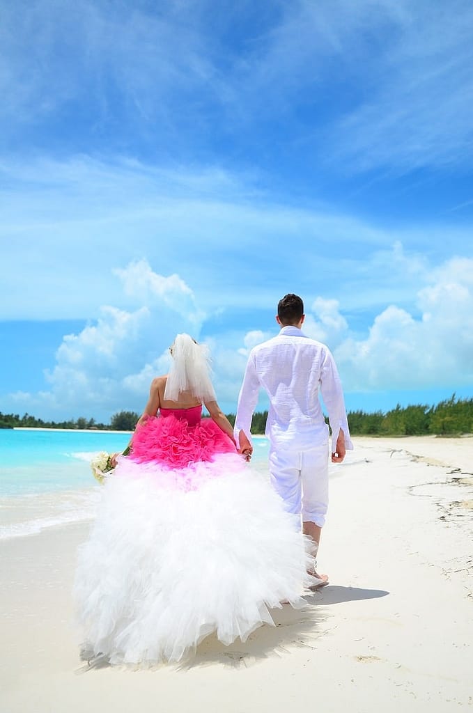  couple walking down the beach in Bahamas