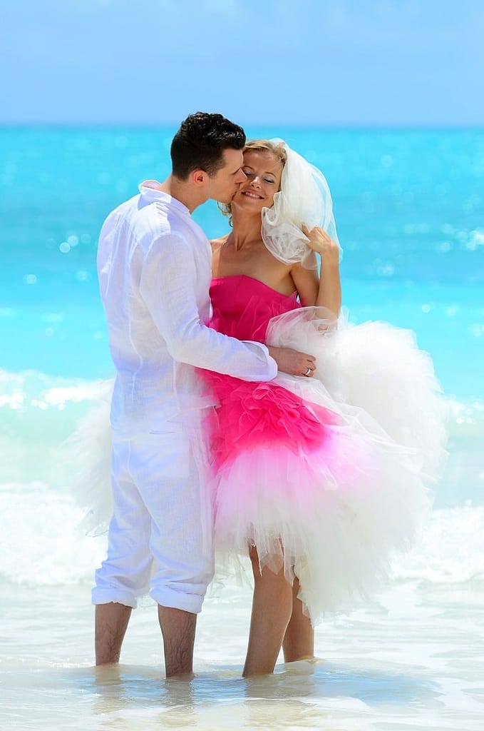  couple on the beach kissing after their ceremony 