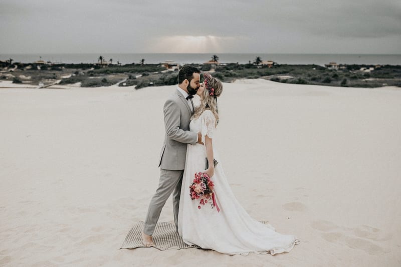 wedding couple embracing on the sand