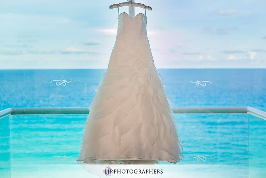  Hanging wedding dress with ocean in background 