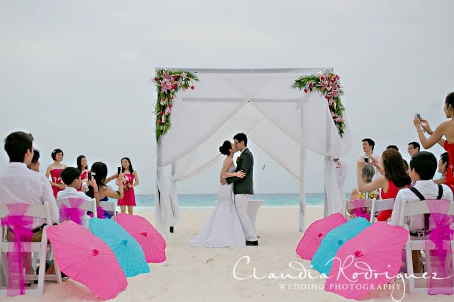 pink and blue umbrellas are great at this ceremony 