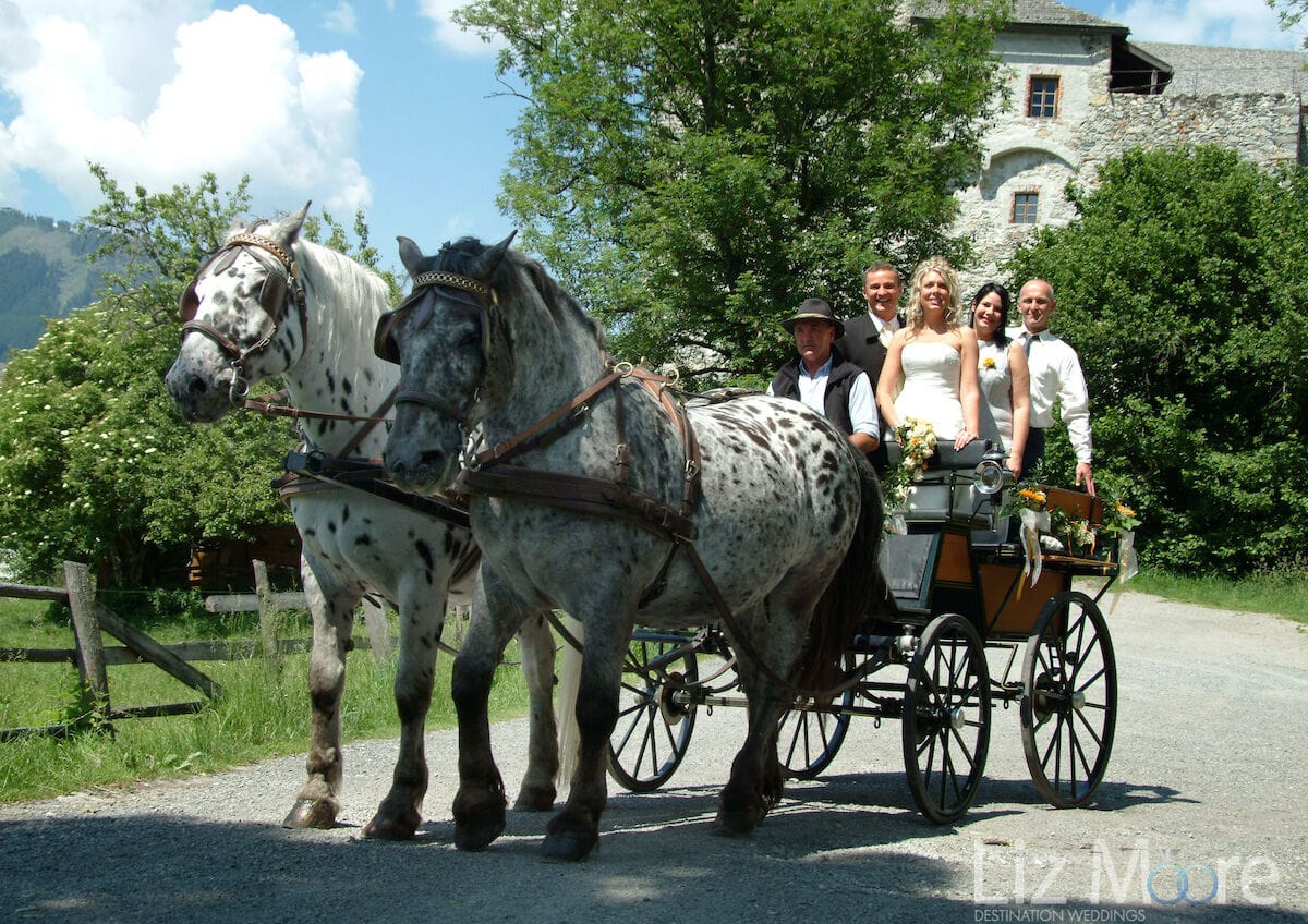 Bride and groom with horse drawn carriage in Austria